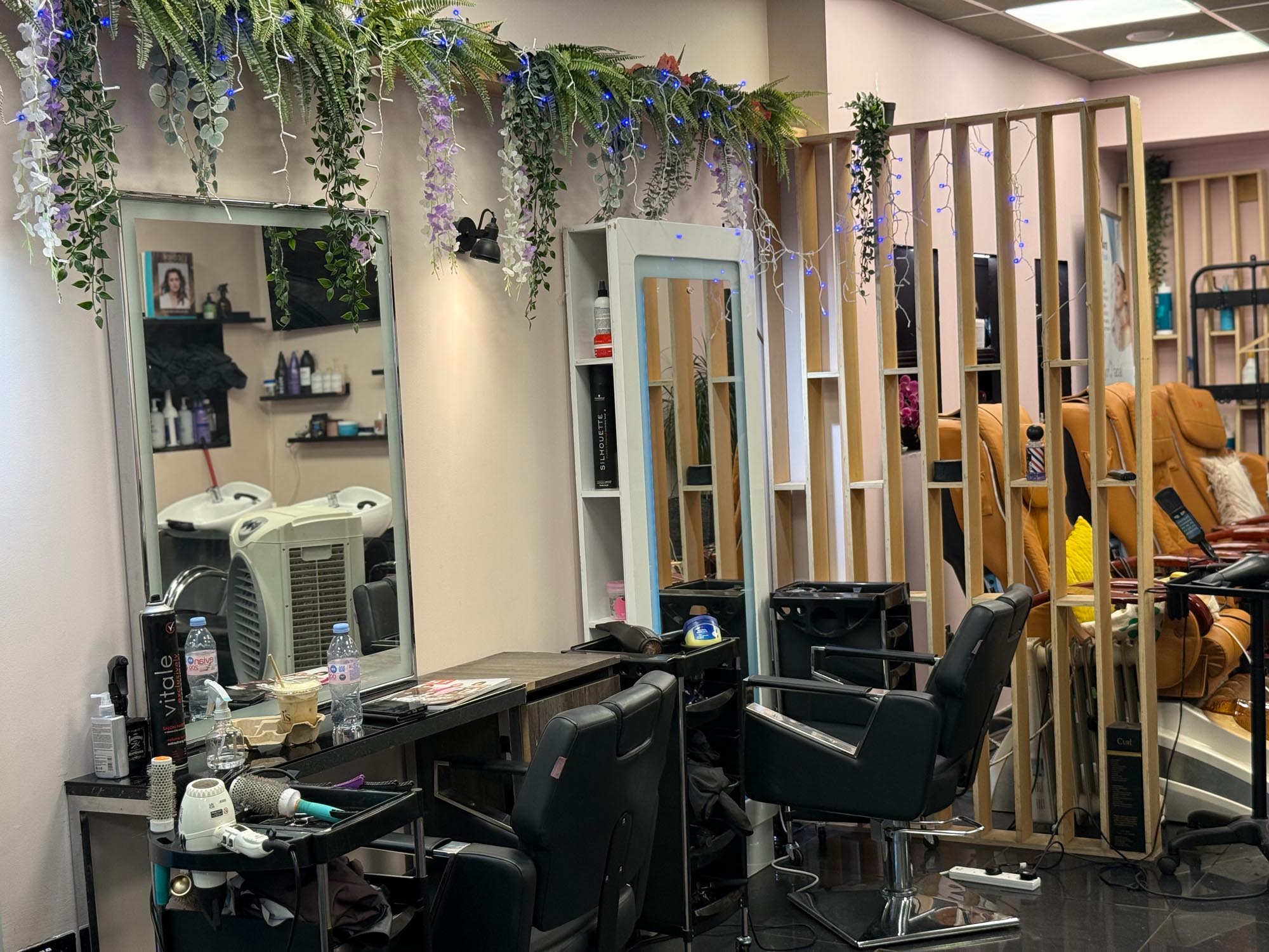 Slatted timber divider separating the pedicure chairs.